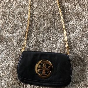 Black Tory Burch Reva Clutch with gold hardware.